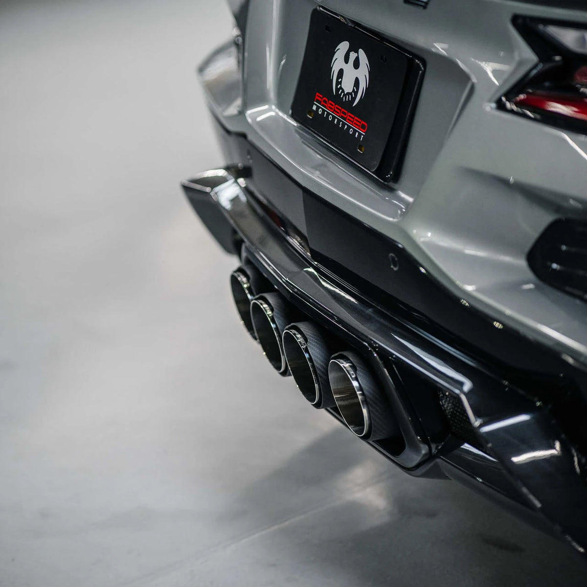 Performance quad exhaust tips on a sports car